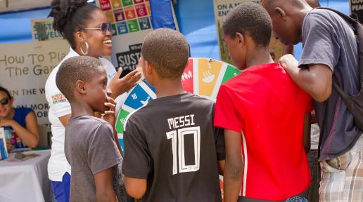 UN Jamaica team member, Jheanelle Hemmings takes these young patrons through the wheel game